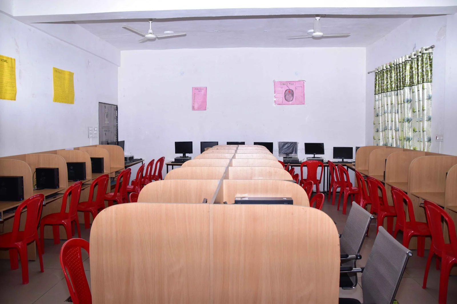 Computer lab with modern computer workstations and ergonomic chairs