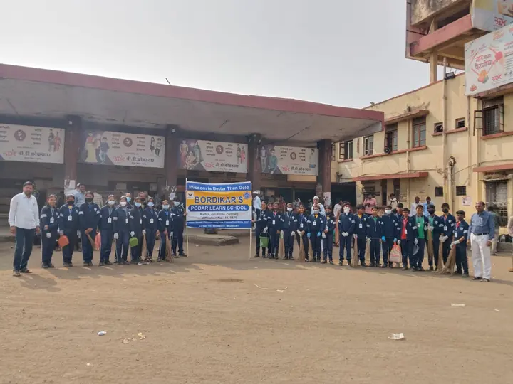 Students lined up outdoors with school banners
