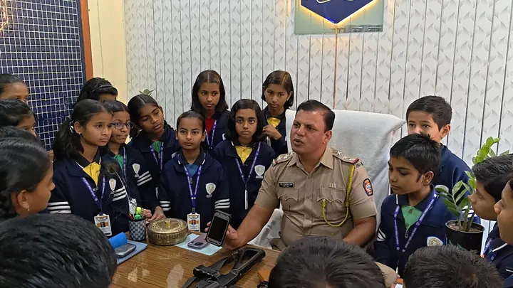 Students listening to a police officer during a visit to the police station